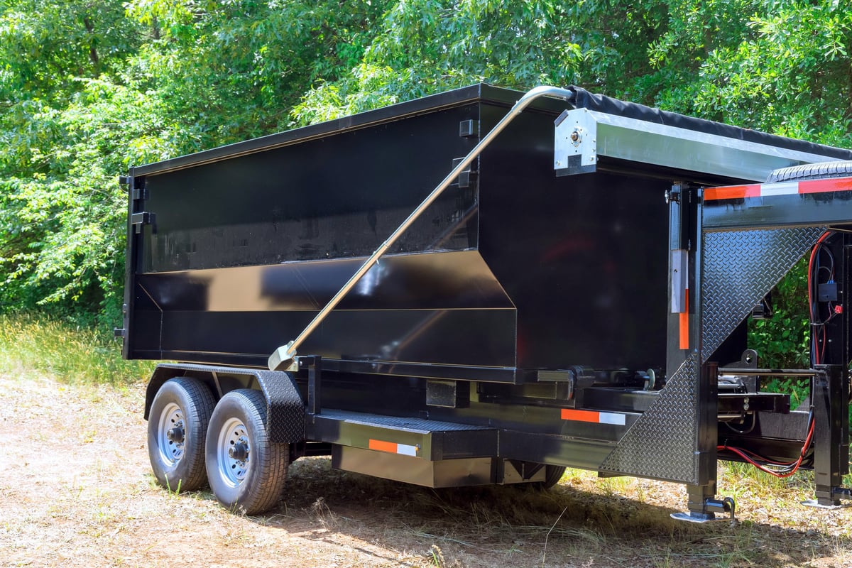 Truck unloading a container of construction waste